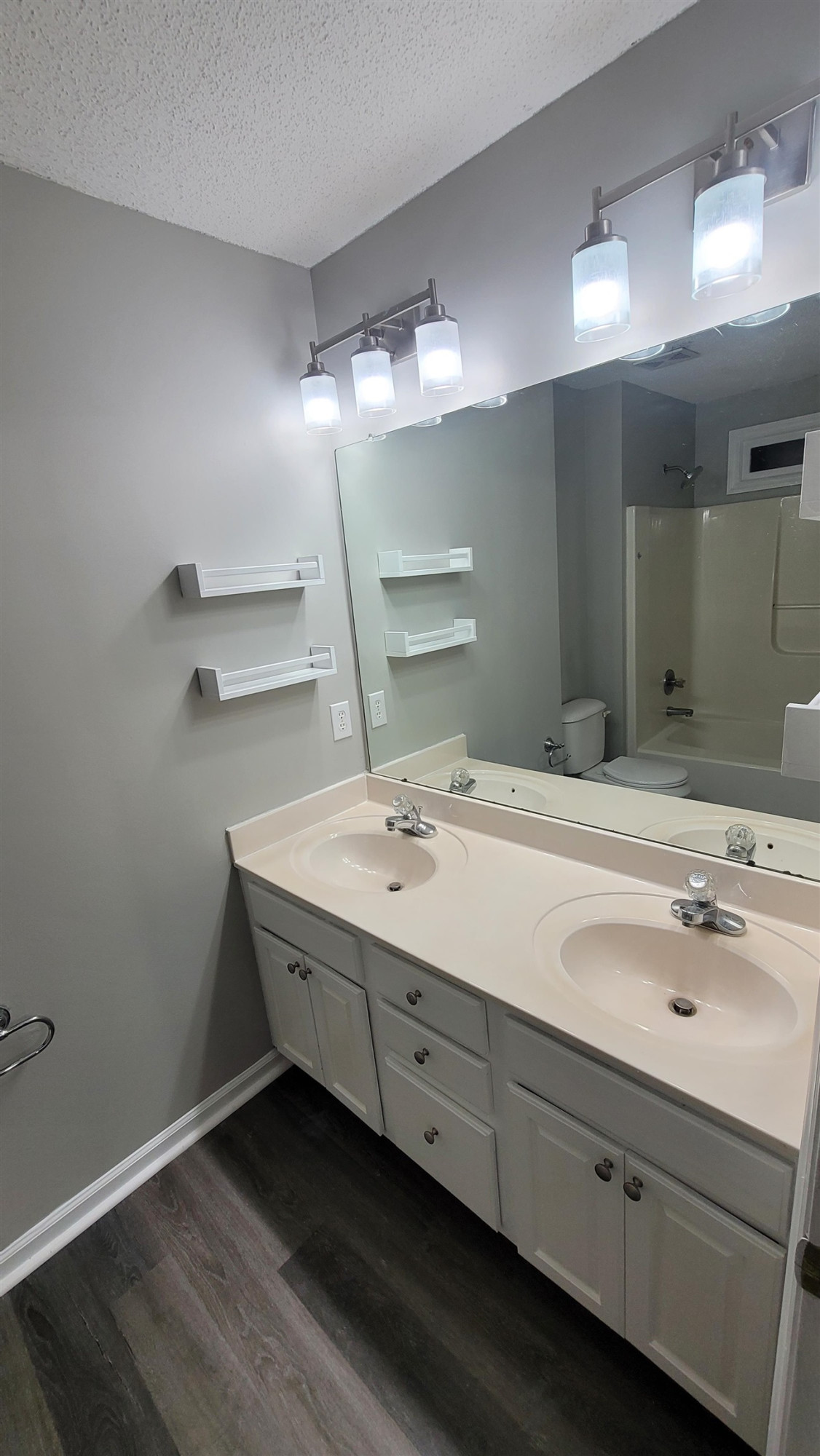 3809 Axle Lane Raleigh, NC 27616 - Photo 10 of 30 a bathroom with a double vanity sink and a mirror