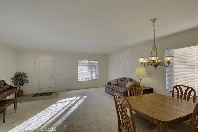 a view of a dining room with furniture and window