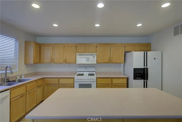 a kitchen with stainless steel appliances a refrigerator sink and cabinets
