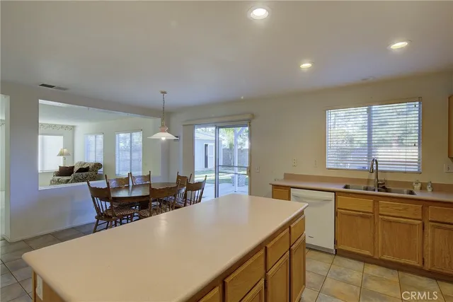 a large kitchen with kitchen island a sink table and chairs