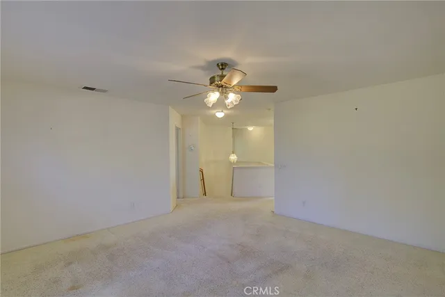 a view of a chandelier fan and entryway