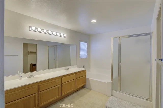 a spacious bathroom with a double vanity sink and a mirror