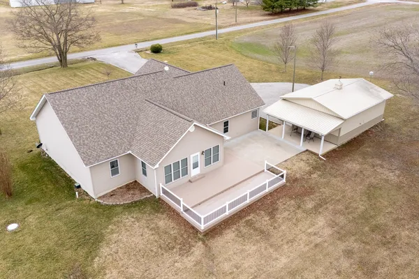 an aerial view of a house with big yard