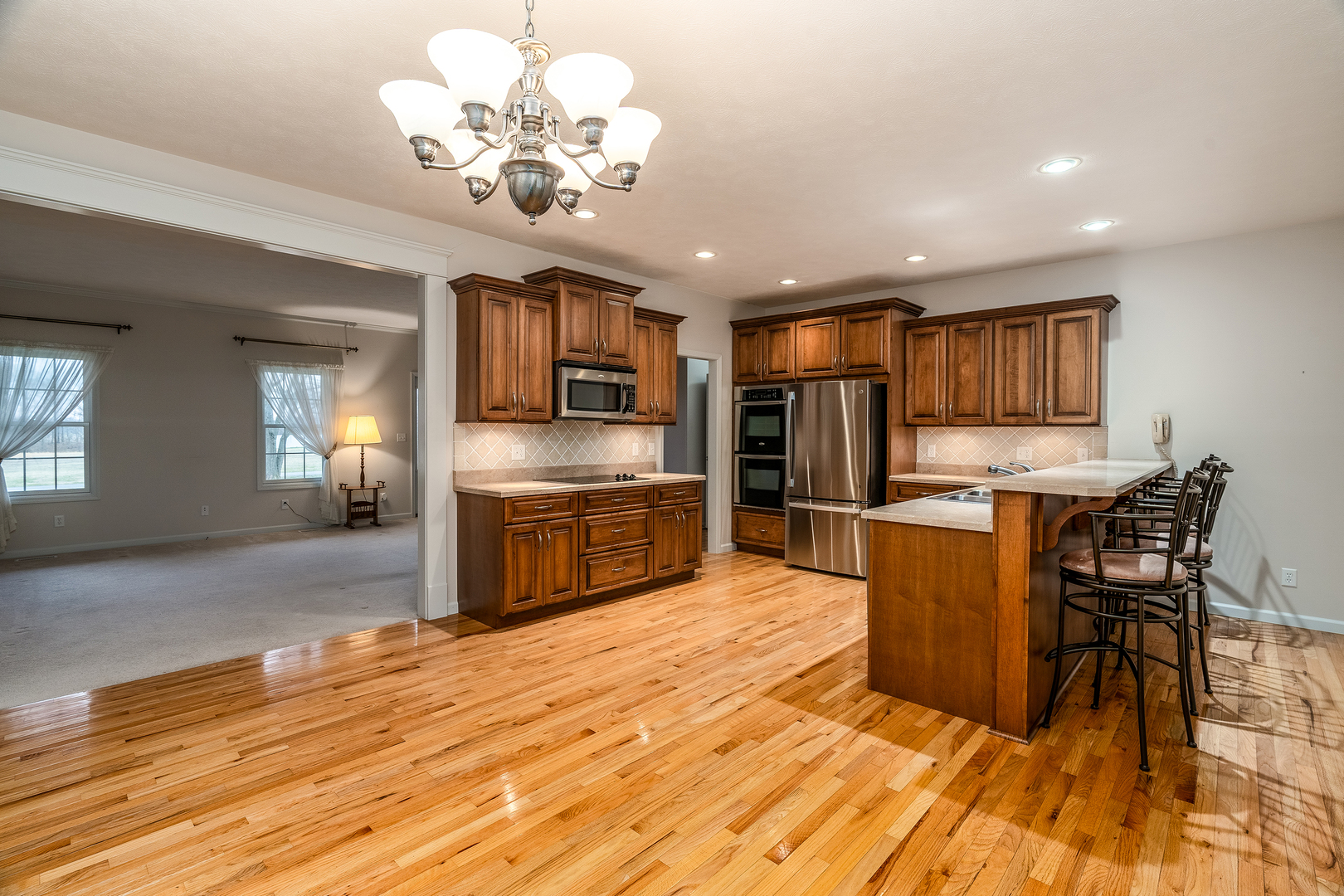 8511 Knox Road West Frankfort, IL 62896 - Photo 25 of 47 a kitchen with stainless steel appliances granite countertop a stove top oven a sink dishwasher a dining table and chairs with wooden floor