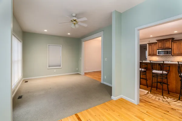 a kitchen with stainless steel appliances kitchen island granite countertop a table and chairs