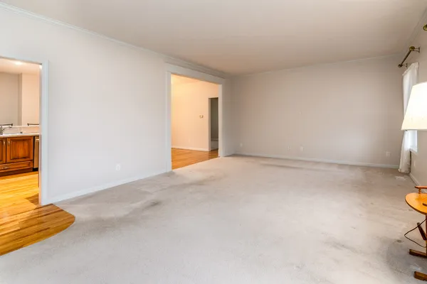 a view of an empty room and a window