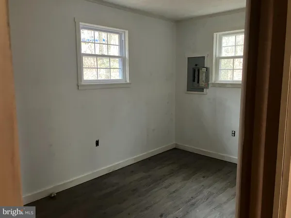 a picture of a room with a ceiling fan and window