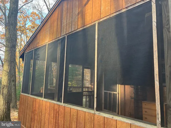 a view of a house with a wooden fence