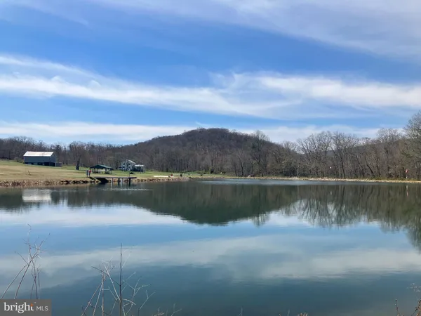 a view of a lake with houses in the back