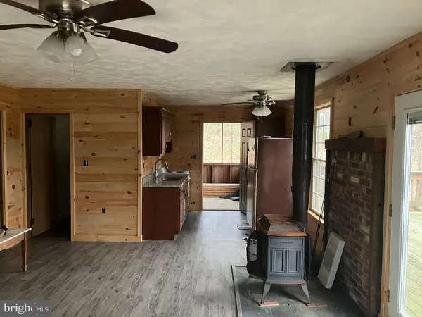 a hallway with a wooden floor and furniture