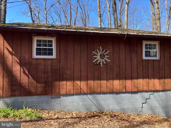 a view of a balcony with wooden floor and floor to ceiling window