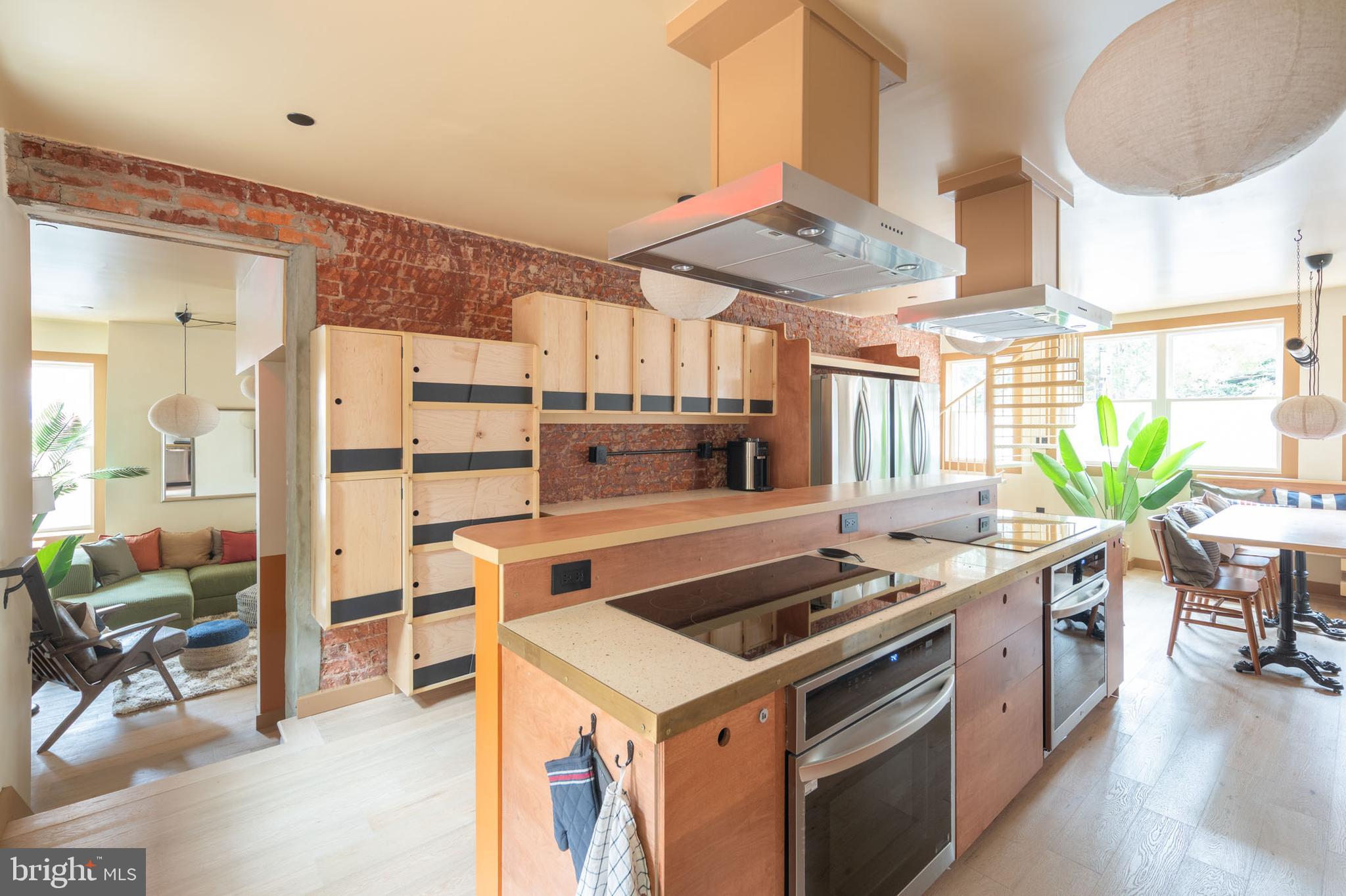 2021 4th Street Northwest Washington, DC 20001 - Photo 11 of 27 a kitchen with stainless steel appliances a stove a chimney a sink and cabinets