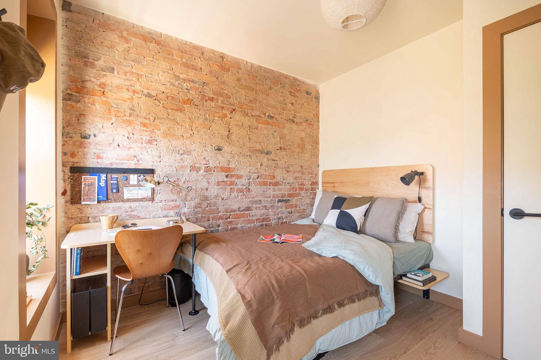 2021 4th Street Northwest Washington, DC 20001 - Photo 14 of 27 a bedroom with a bed and a table in it