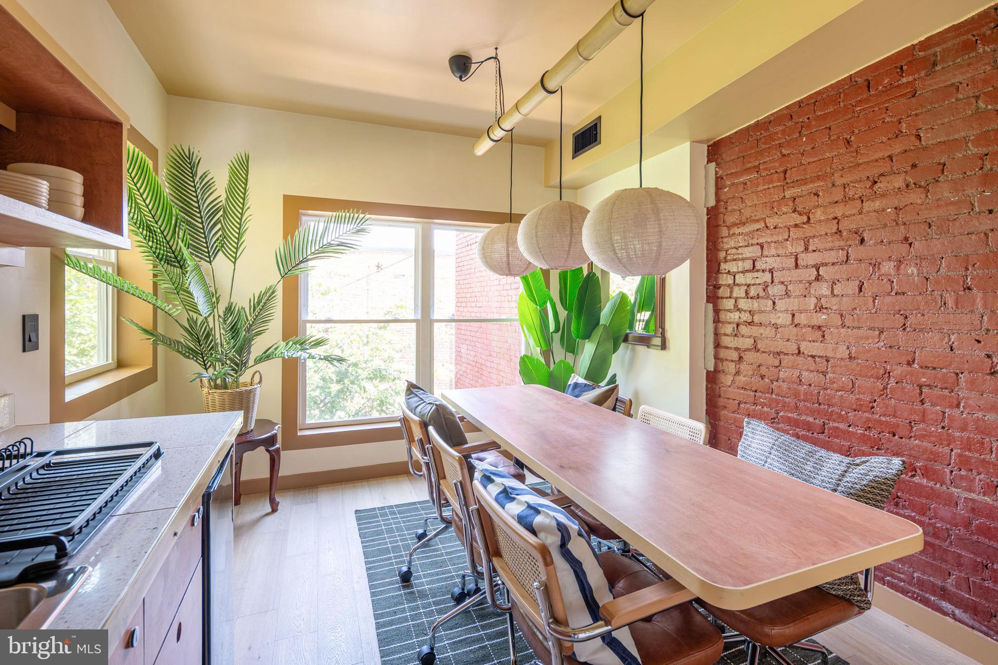 2021 4th Street Northwest Washington, DC 20001 - Photo 16 of 27 a view of a dining room with furniture a chandelier and wooden floor