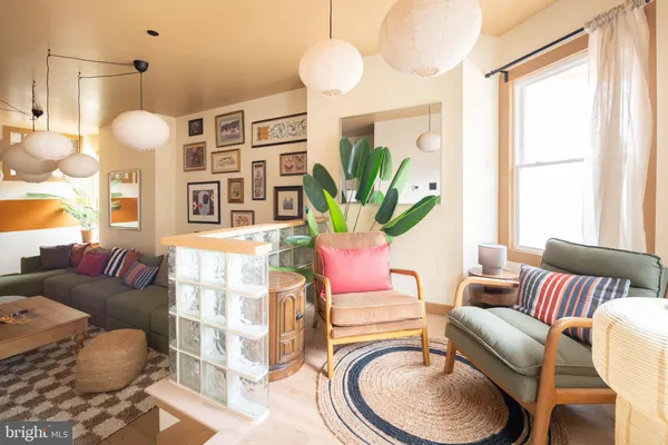 a living room with furniture a chandelier and a large mirror