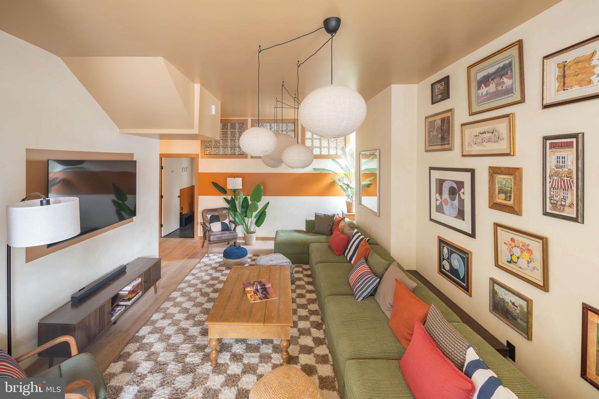 2021 4th Street Northwest Washington, DC 20001 - Photo 5 of 27 a living room filled with furniture and a chandelier