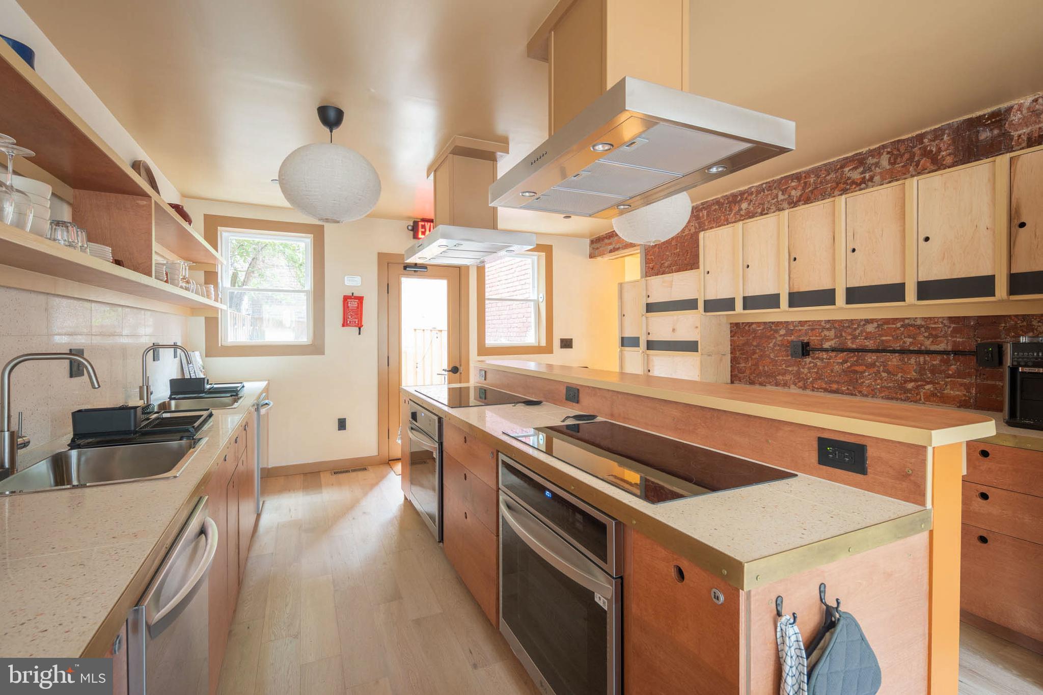 2021 4th Street Northwest Washington, DC 20001 - Photo 9 of 27 a kitchen with stainless steel appliances a sink stove and cabinets