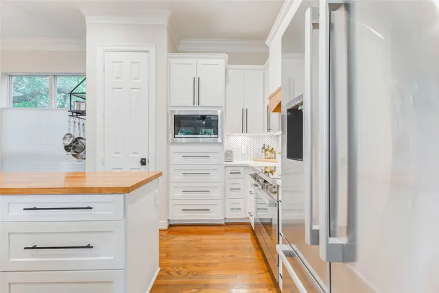 a kitchen with a sink appliances and a window