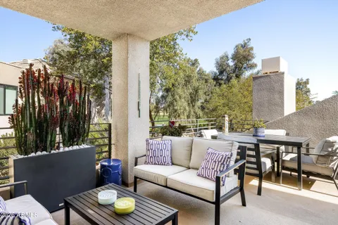 a view of city from deck with patio