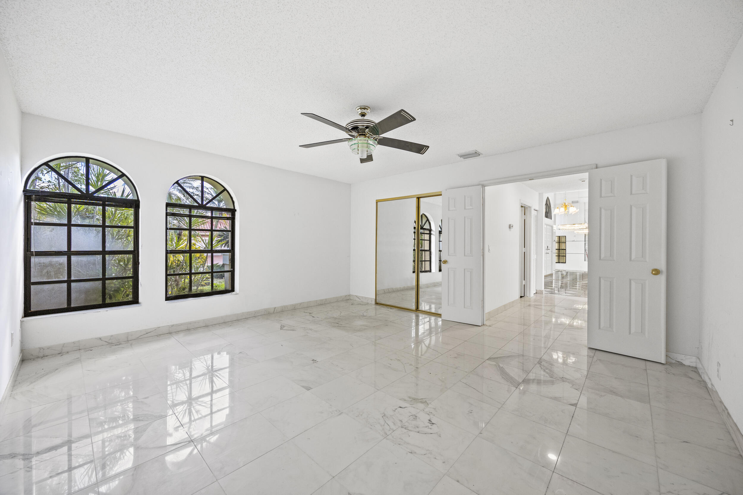 10747 Stonebridge Boulevard Boca Raton, FL 33498 - Photo 28 of 75 a view of an empty room with a window and a ceiling fan
