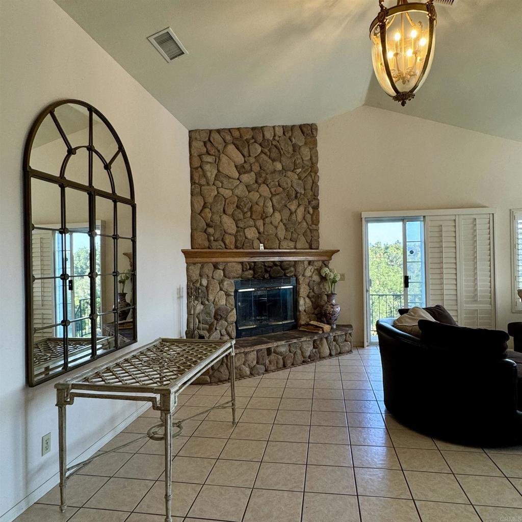 2848 Los Alisos Drive Fallbrook, CA 92028 - Photo 11 of 74 a living room with furniture a fireplace and a floor to ceiling window