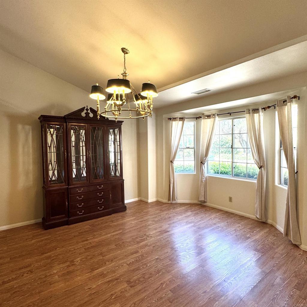 2848 Los Alisos Drive Fallbrook, CA 92028 - Photo 17 of 74 a view of an empty room with wooden floor and a window