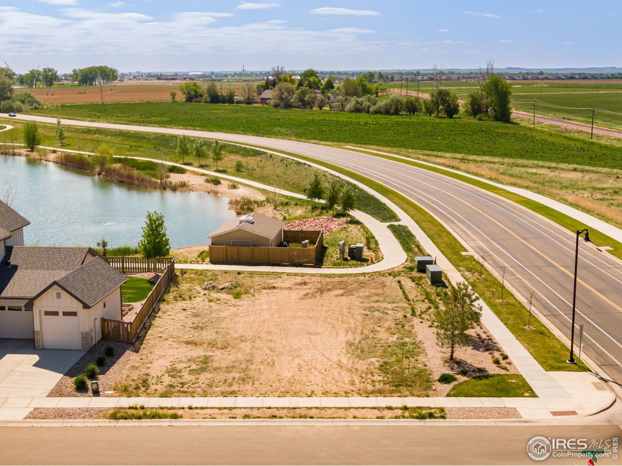 5536 Long Drive Timnath, CO 80547 - Photo 20 of 24 a view of a swimming pool with a lake and mountain view