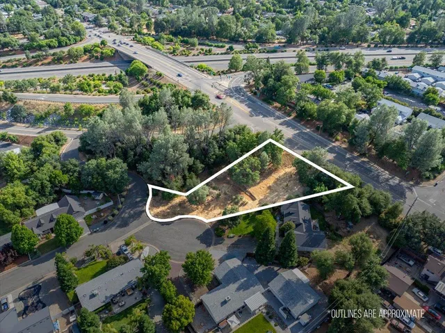 an aerial view of a house with a yard and lake view