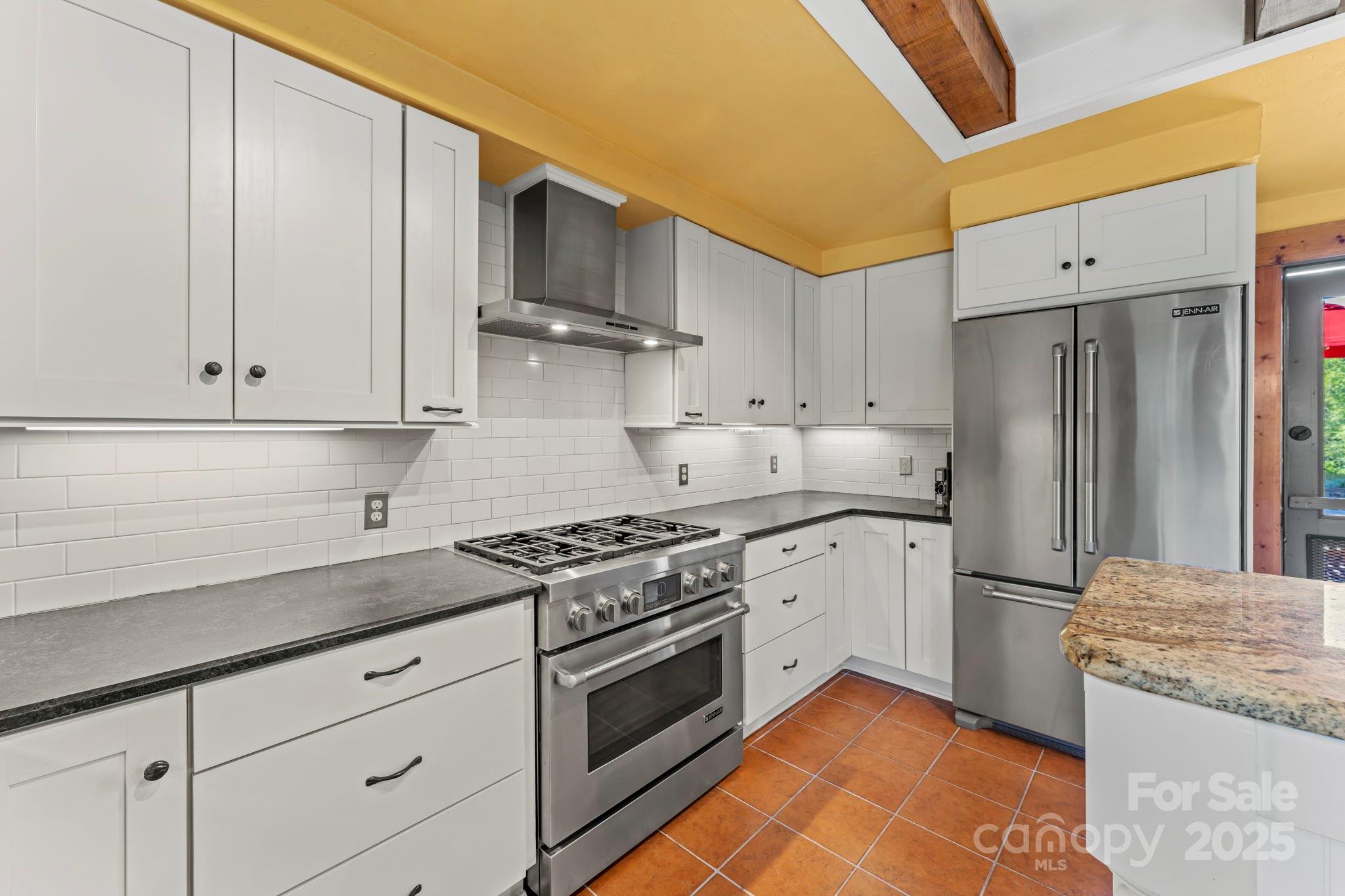222 Stone Hedge Lane Tryon, NC 28782 - Photo 12 of 48 a kitchen with stainless steel appliances granite countertop a stove a refrigerator and a sink