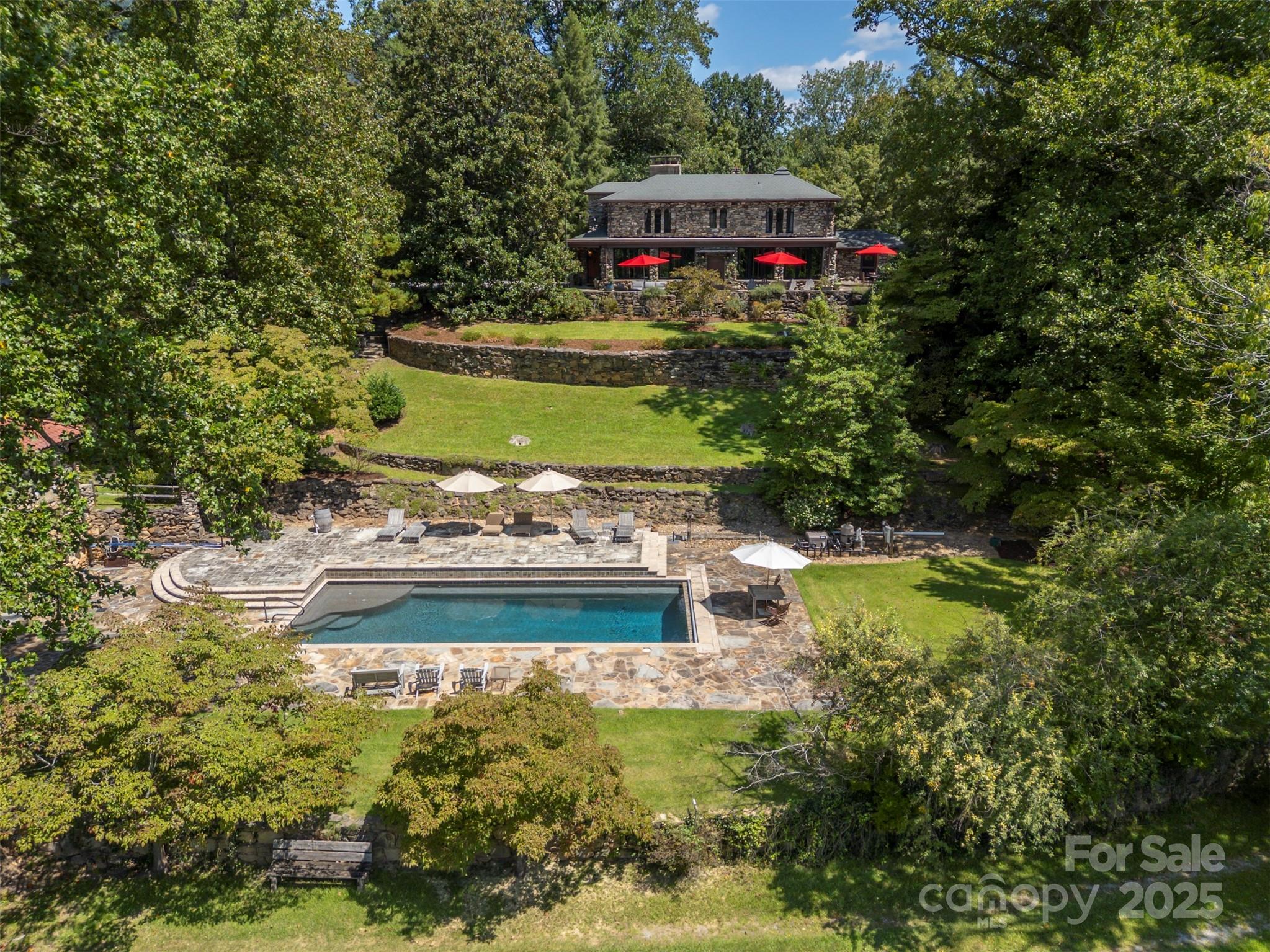222 Stone Hedge Lane Tryon, NC 28782 - Photo 2 of 48 a view of a garden with a small house