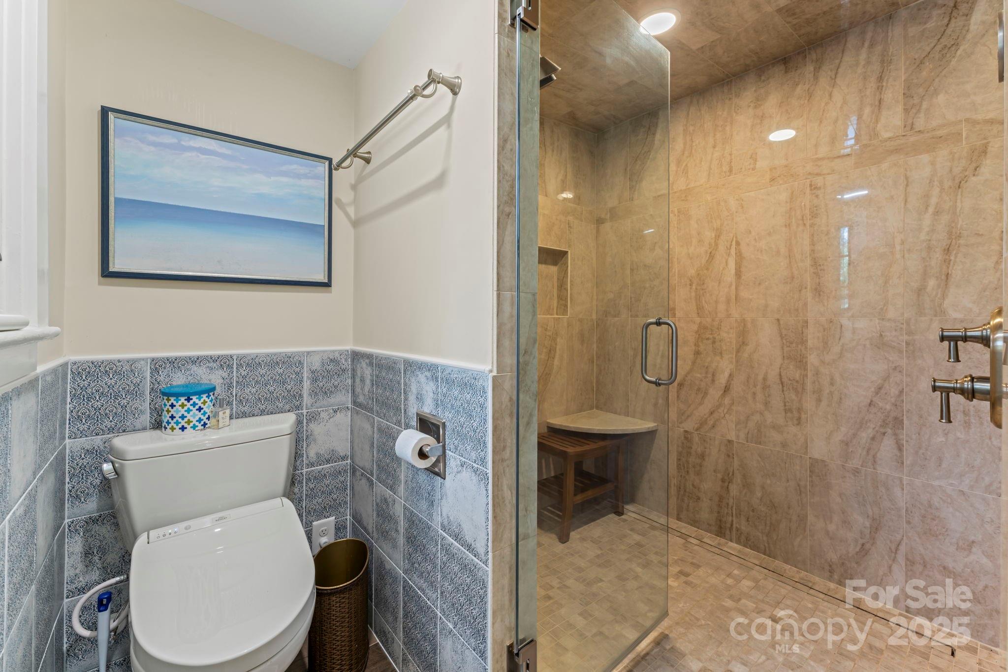 222 Stone Hedge Lane Tryon, NC 28782 - Photo 25 of 48 a white toilet sitting next to a bathroom sink