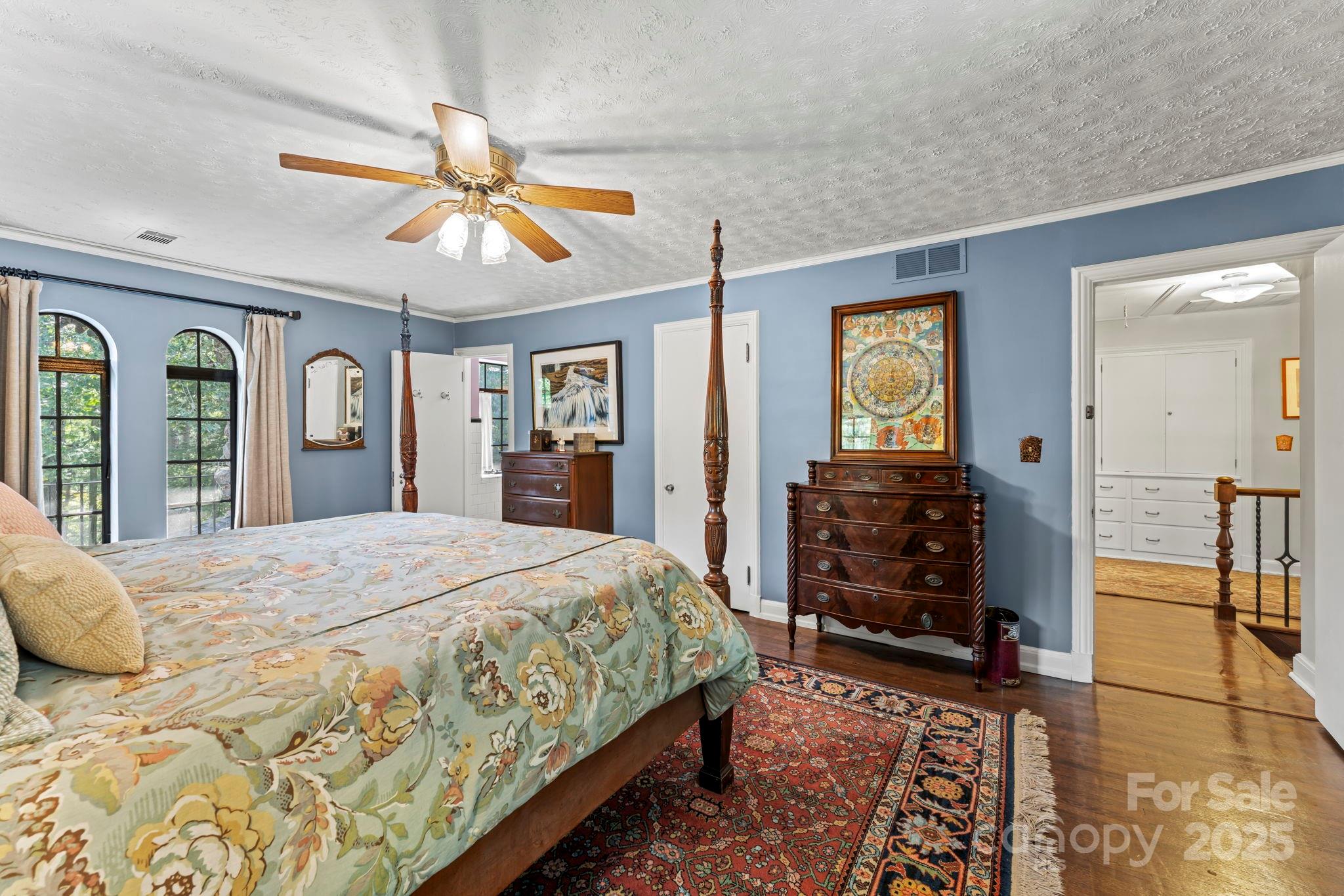 222 Stone Hedge Lane Tryon, NC 28782 - Photo 27 of 48 a bedroom with a bed and a chandelier