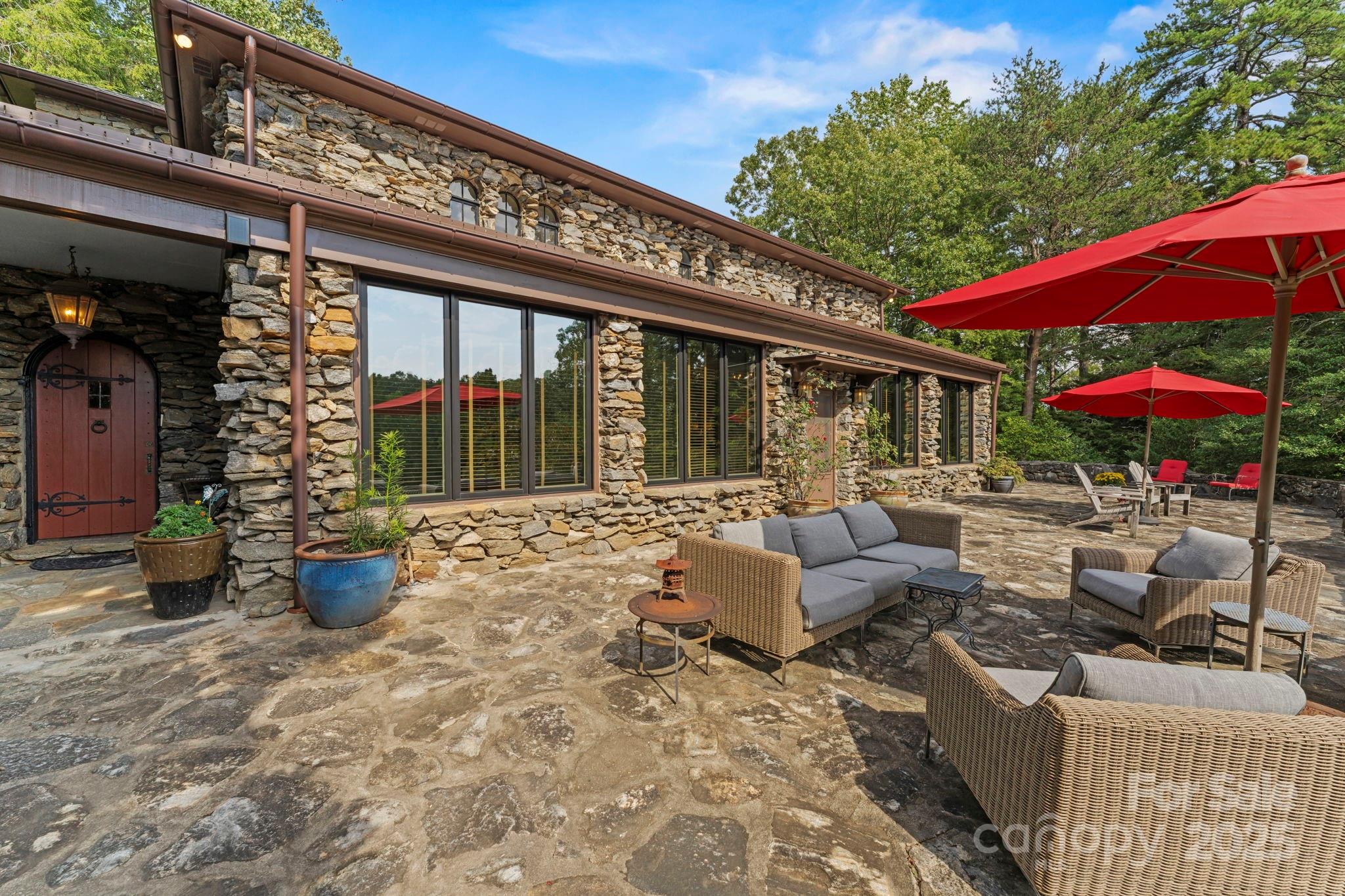 222 Stone Hedge Lane Tryon, NC 28782 - Photo 30 of 48 a view of patio with a table and chairs under an umbrella