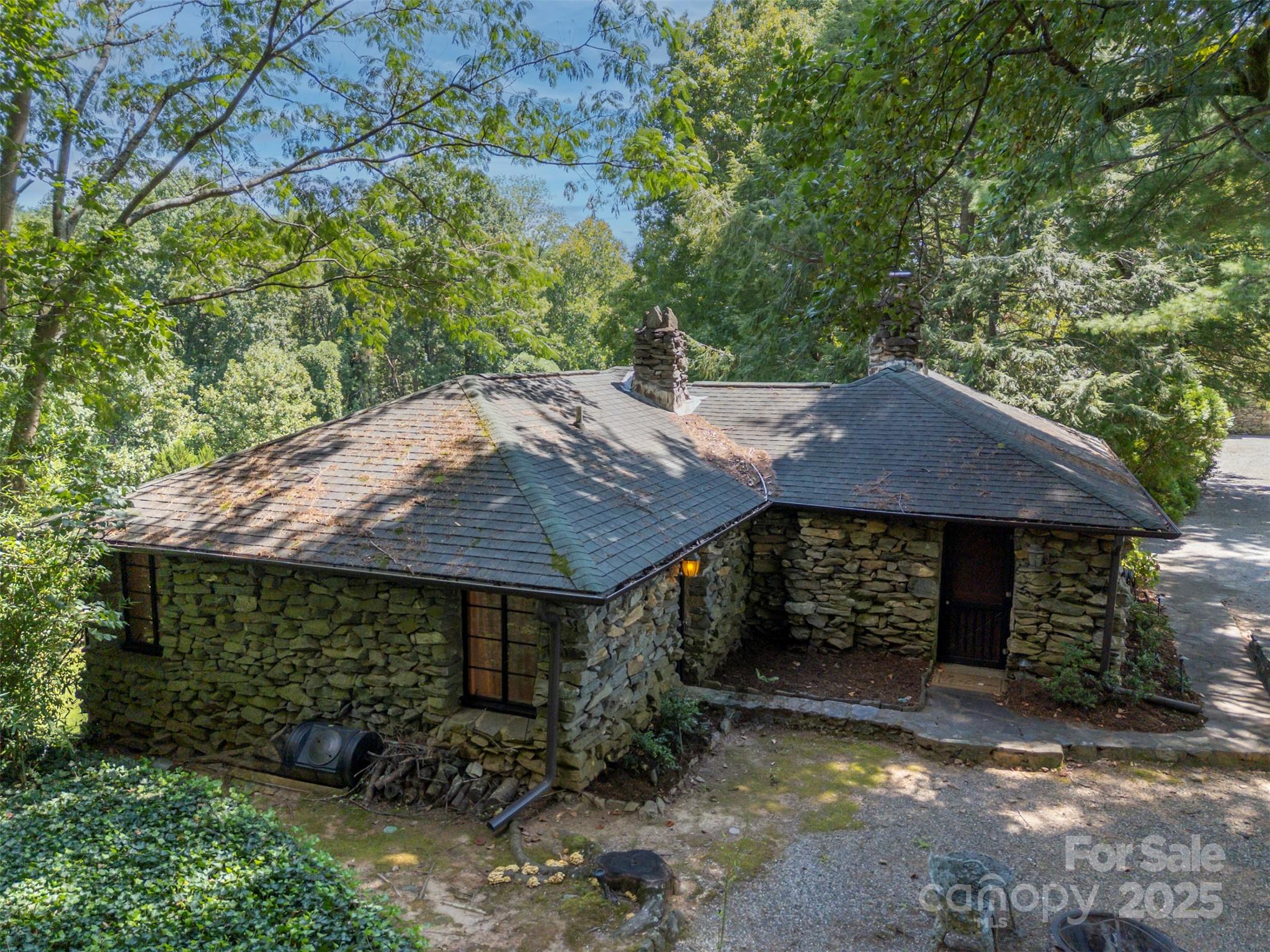 222 Stone Hedge Lane Tryon, NC 28782 - Photo 36 of 48 a view of a barn with big yard plants and large trees