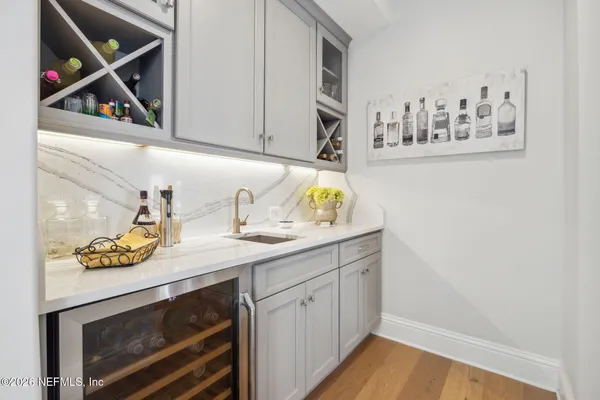 a view with kitchen island a sink appliances and a counter top space