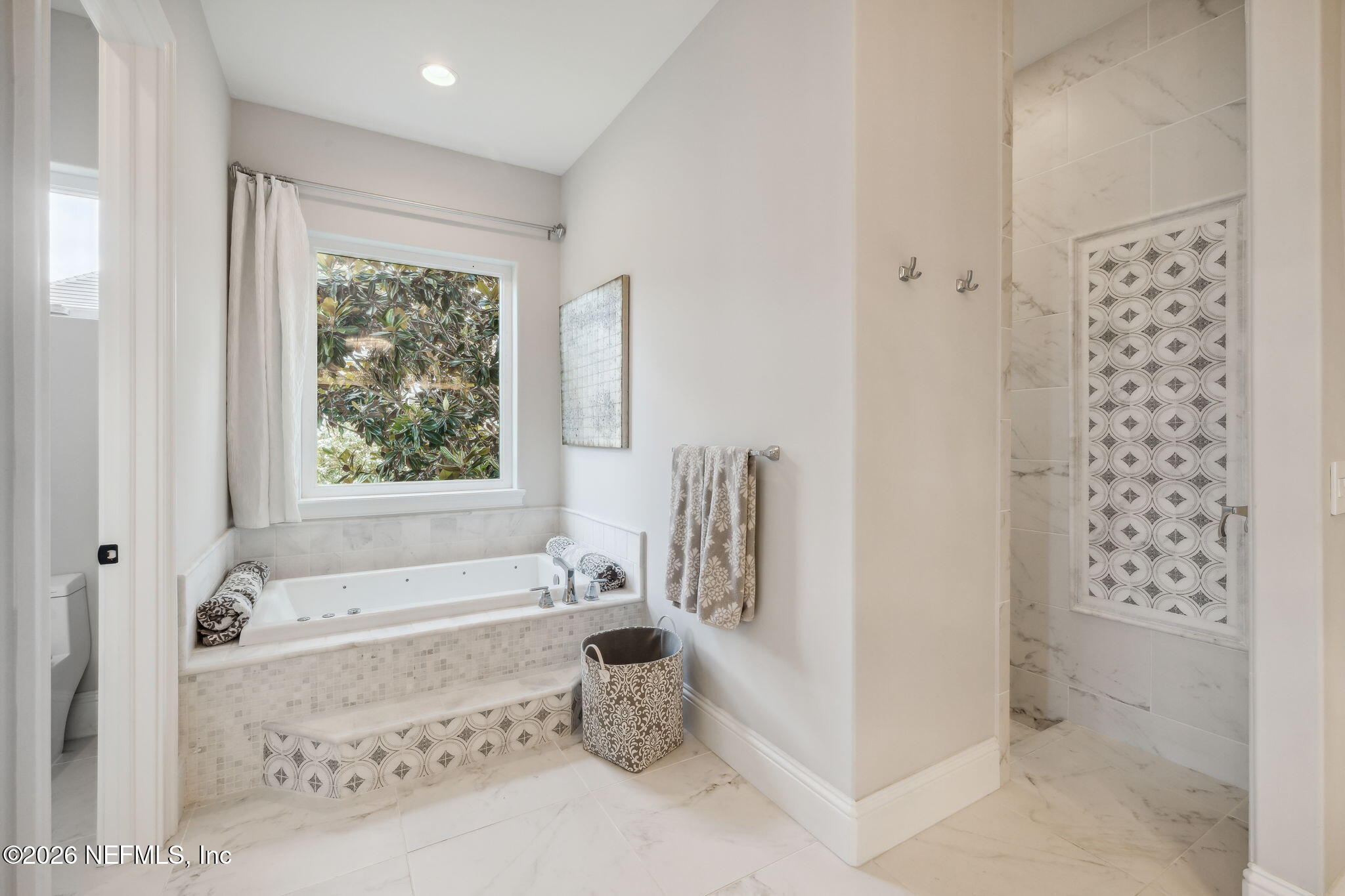 5275 Bentpine Cove Road Jacksonville, FL 32224 - Photo 34 of 95 a bathroom with a bathtub and a shower