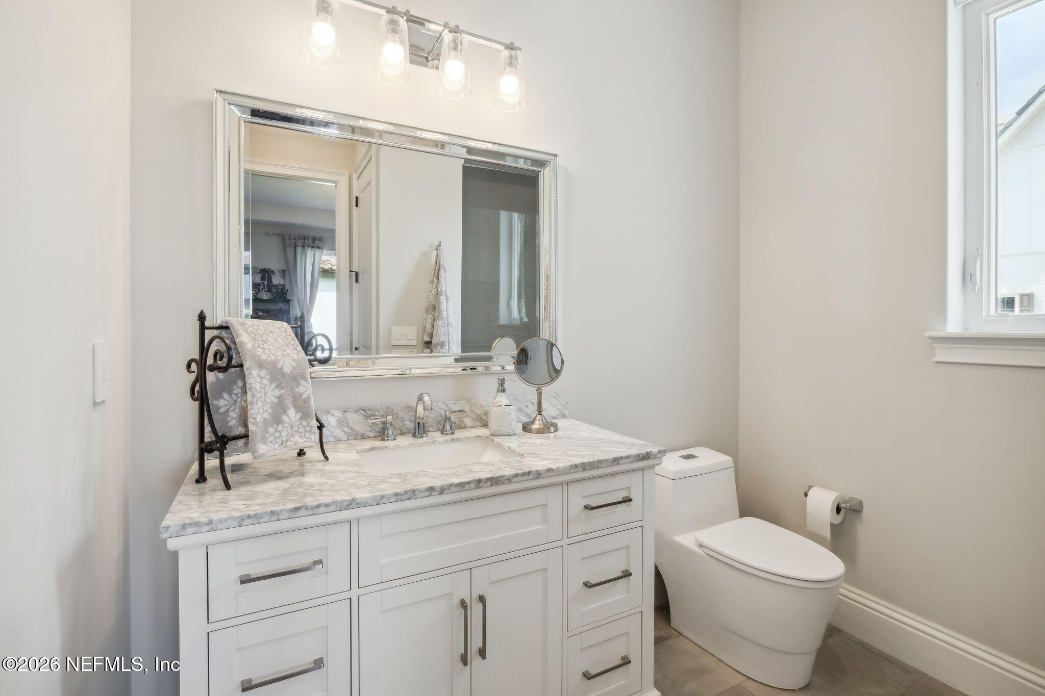5275 Bentpine Cove Road Jacksonville, FL 32224 - Photo 43 of 95 a bathroom with a granite countertop toilet sink and mirror