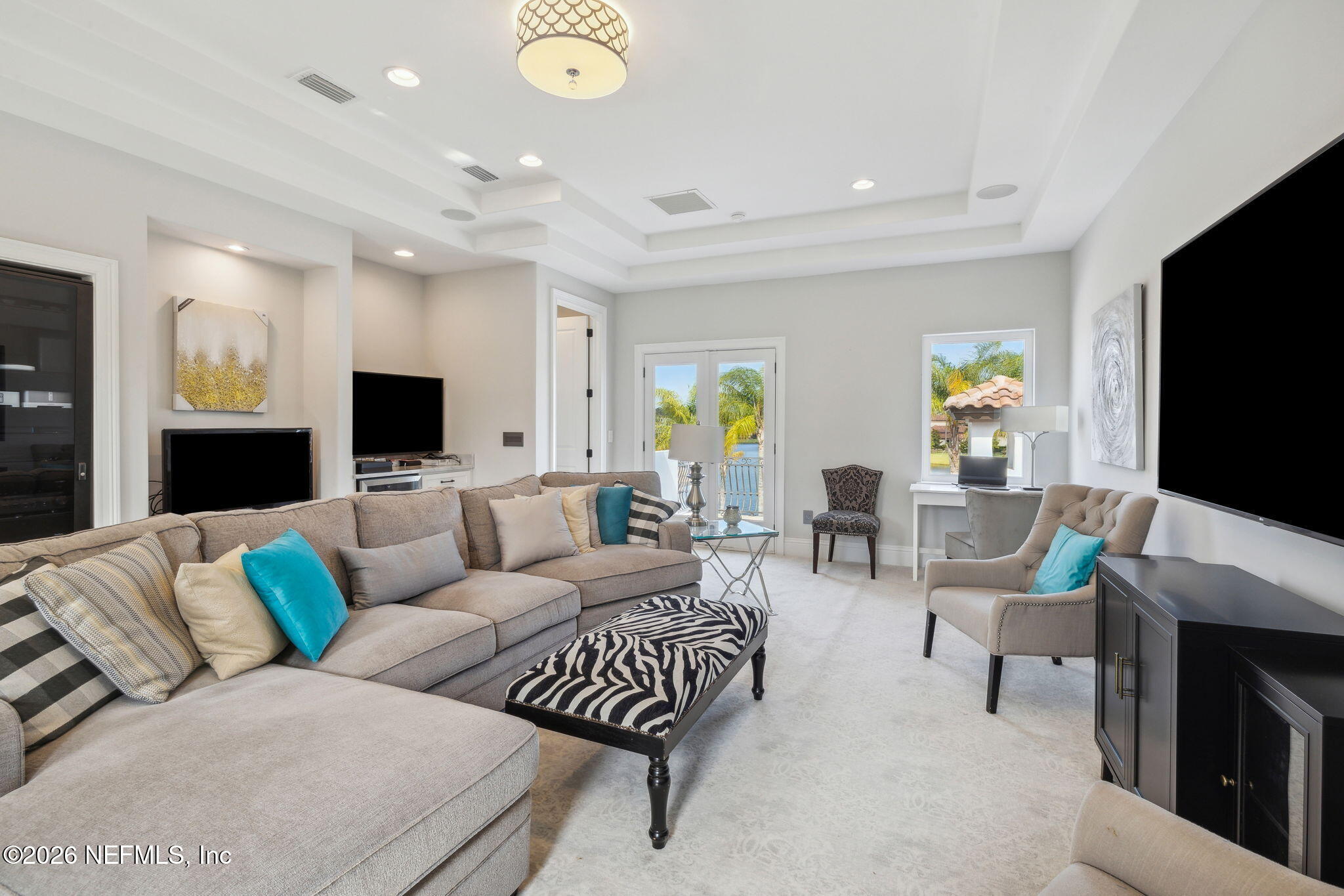 5275 Bentpine Cove Road Jacksonville, FL 32224 - Photo 54 of 95 a living room with furniture and a flat screen tv