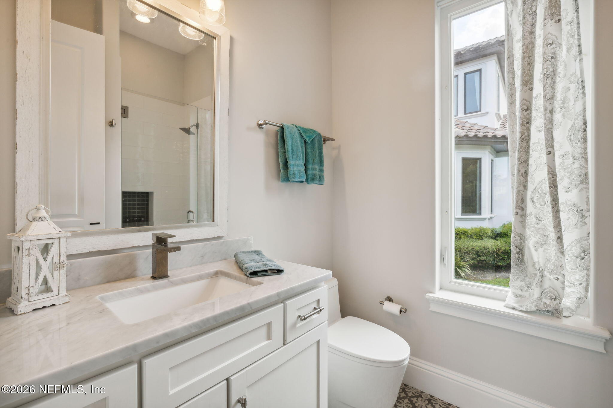 5275 Bentpine Cove Road Jacksonville, FL 32224 - Photo 72 of 95 a bathroom with a granite countertop sink mirror and a toilet