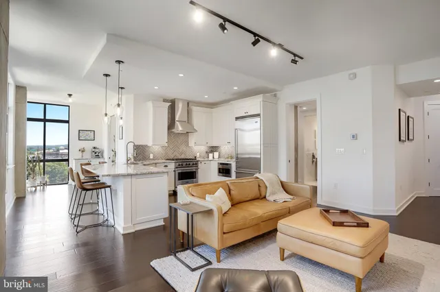 a living room with furniture and wooden floor