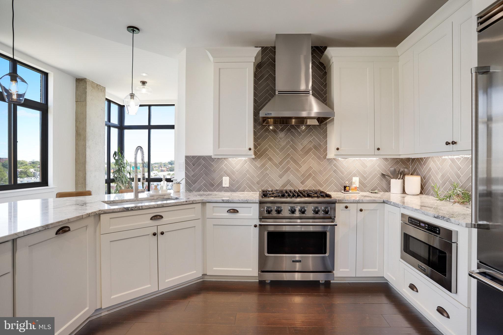 1000 New Jersey Avenue Southeast, Unit 1020 Washington, DC 20003 - Photo 14 of 60 a kitchen with stainless steel appliances a stove a sink and cabinets