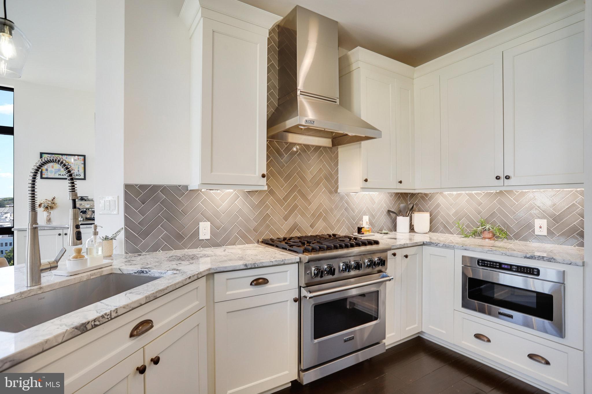 1000 New Jersey Avenue Southeast, Unit 1020 Washington, DC 20003 - Photo 15 of 60 a kitchen with granite countertop a stove and a sink