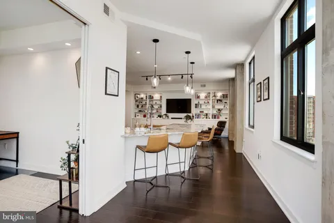 a view of empty room with wooden floor and floor to ceiling window