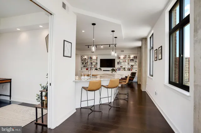 a view of empty room with wooden floor and floor to ceiling window