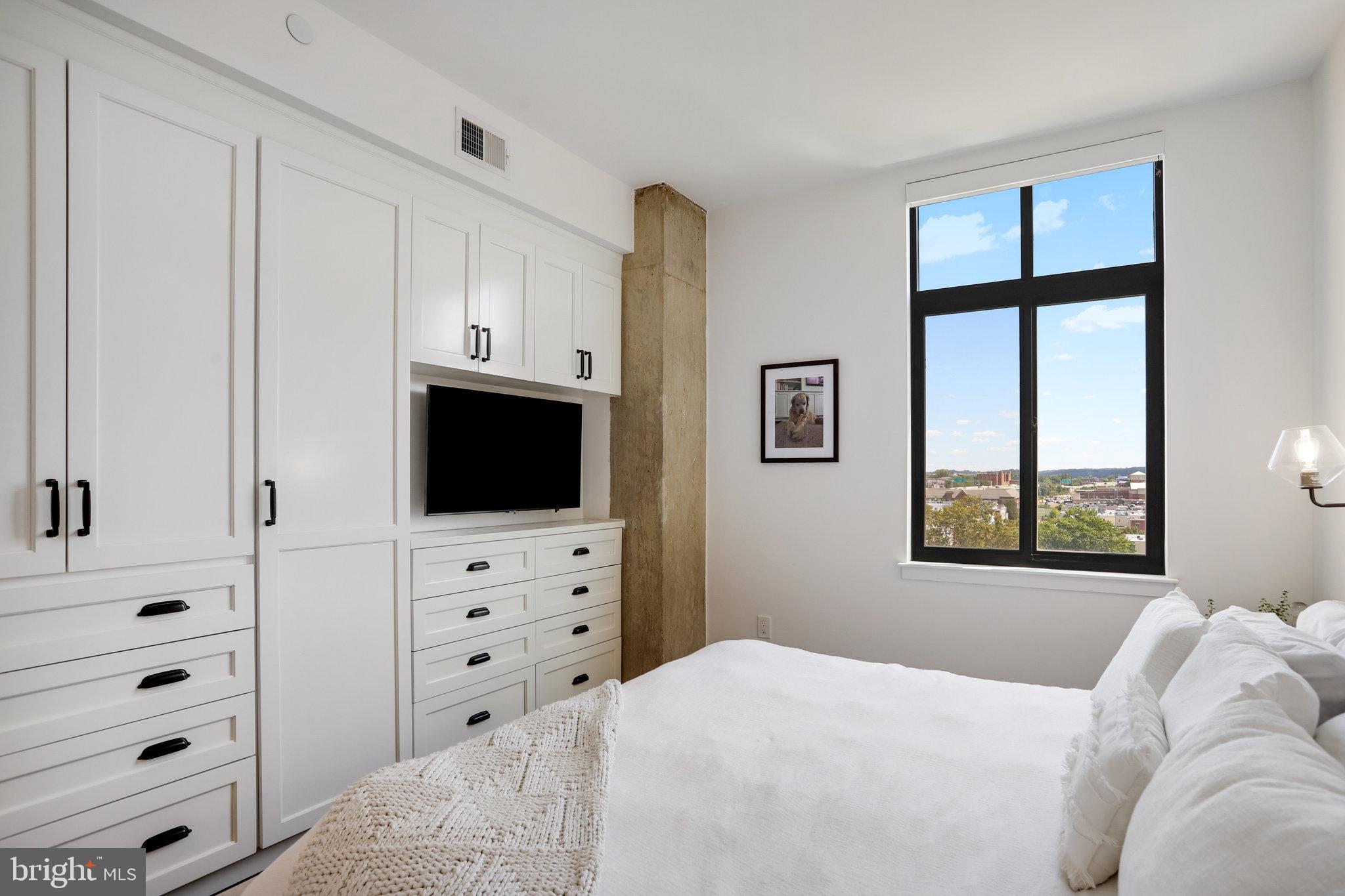 1000 New Jersey Avenue Southeast, Unit 1020 Washington, DC 20003 - Photo 24 of 60 a bedroom with a bed and a flat screen tv