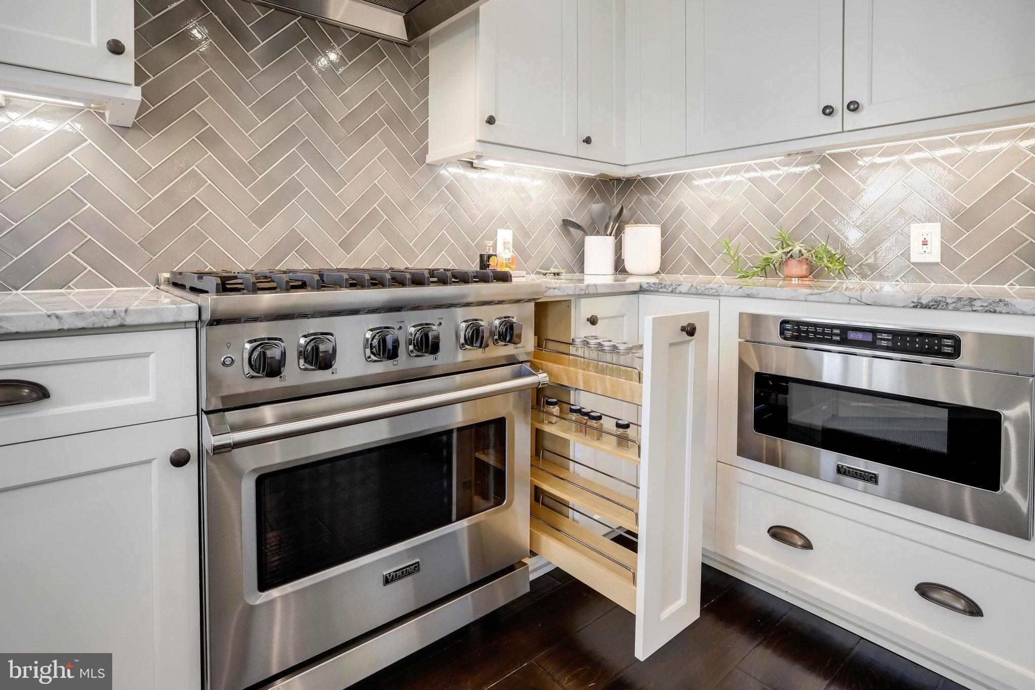 1000 New Jersey Avenue Southeast, Unit 1020 Washington, DC 20003 - Photo 35 of 60 a stove top oven sitting inside of a kitchen