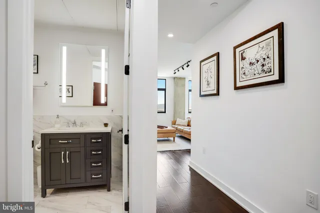 a view of a workspace with furniture and wooden floor