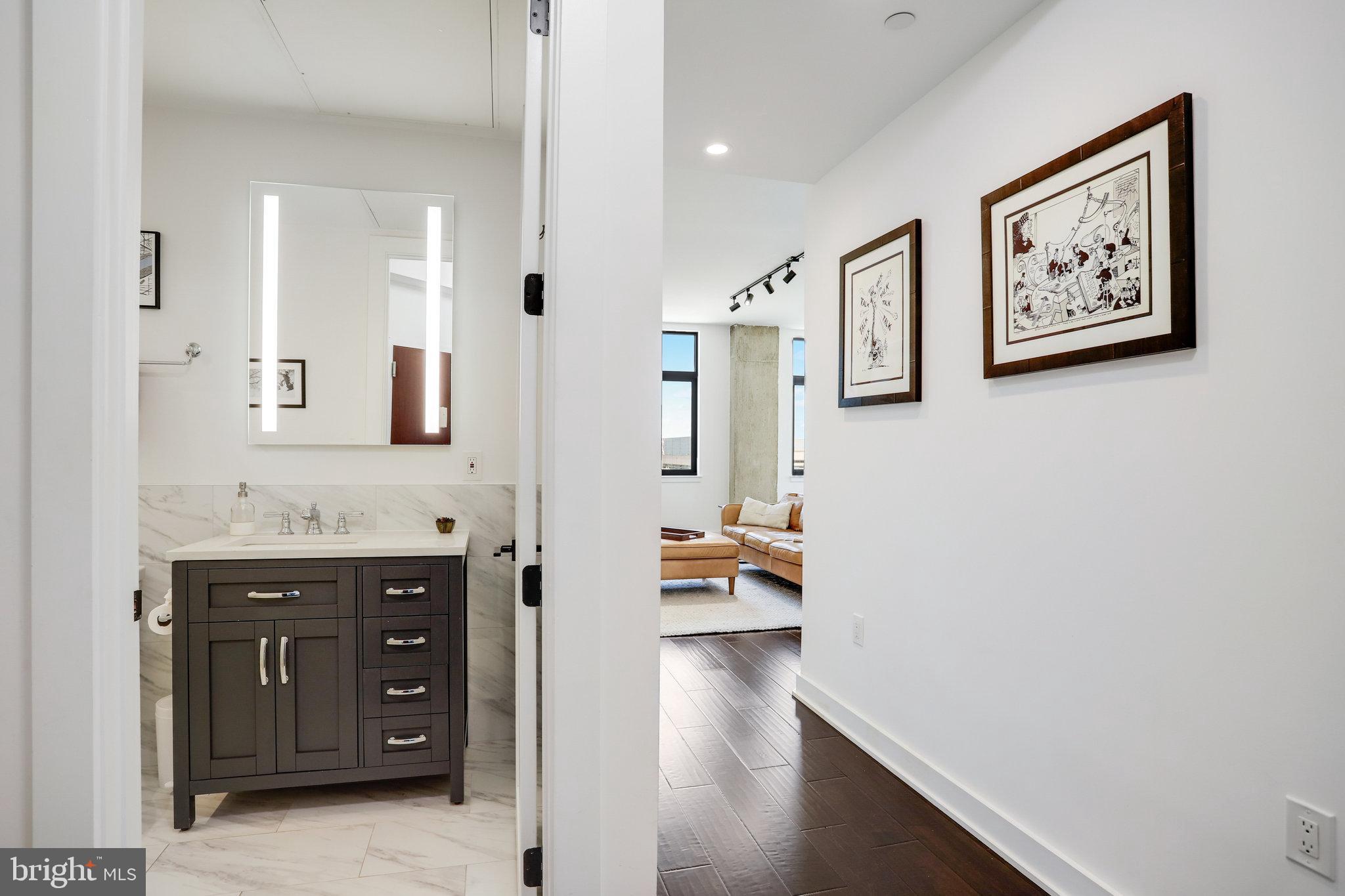 1000 New Jersey Avenue Southeast, Unit 1020 Washington, DC 20003 - Photo 5 of 60 a spacious bathroom with a tub sink and mirror