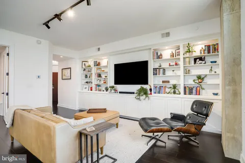 a room with a flat screen tv closet and a couch