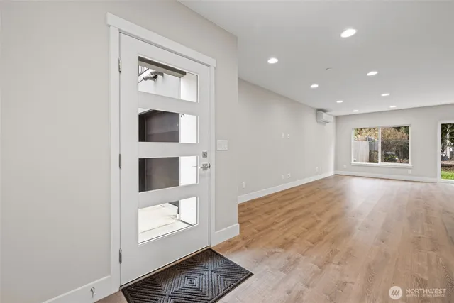 a view of an empty room with a window and fire place